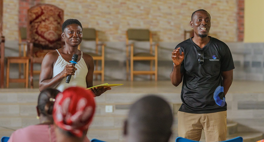 A TransactShield trainer facilitates an interactive session, with a participant contributing to the discussion