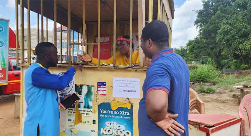 Enumerator interviewing a mobile money agent in Accra