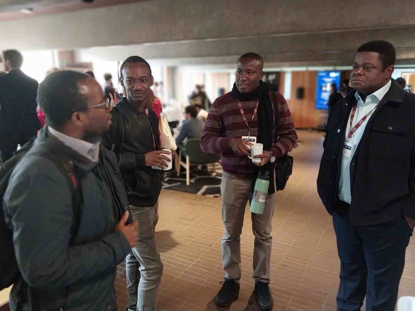 Prof. Quartey engages young researchers in discussions at the ReFinD stand.