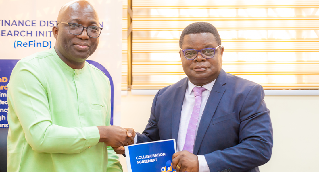 Shaibu Haruna, CEO of MobileMoney Ltd, and Prof. Peter Quartey, Director of ISSER, symbolize their commitment to advancing financial inclusion with a firm handshake after signing a groundbreaking research partnership agreement