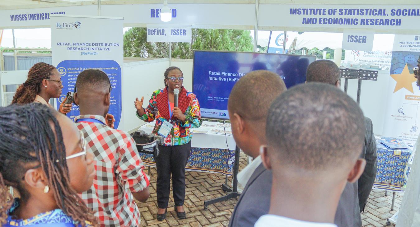 Project Director Adadzewa Otoo engages visitors at the ReFinD exhibition booth, sharing insights into the Initiative’s research, activities, and contributions to advancing digital finance and financial inclusion.