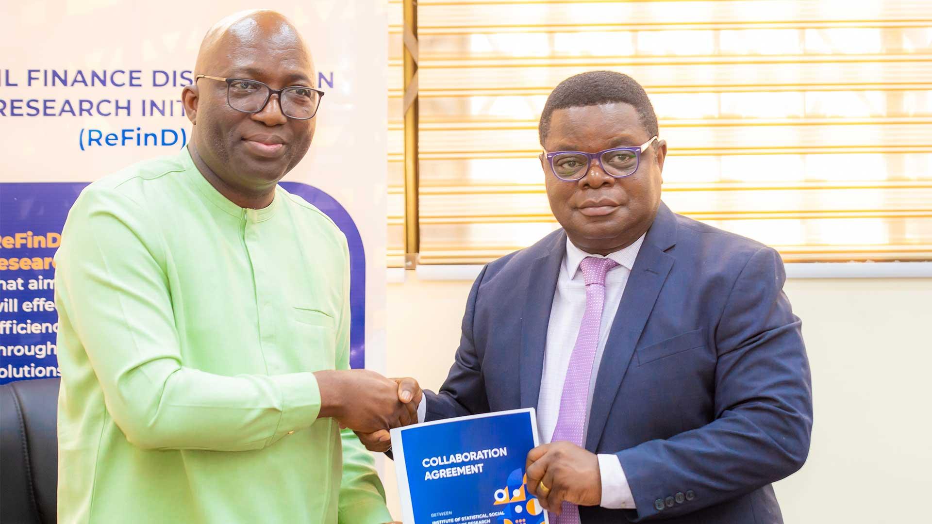 Shaibu Haruna, CEO of MobileMoney Ltd, and Prof. Peter Quartey, Director of ISSER, symbolize their commitment to advancing financial inclusion with a firm handshake after signing a groundbreaking research partnership agreement