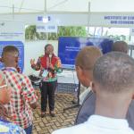 Project Director Adadzewa Otoo engages visitors at the ReFinD exhibition booth, sharing insights into the Initiative’s research, activities, and contributions to advancing digital finance and financial inclusion.